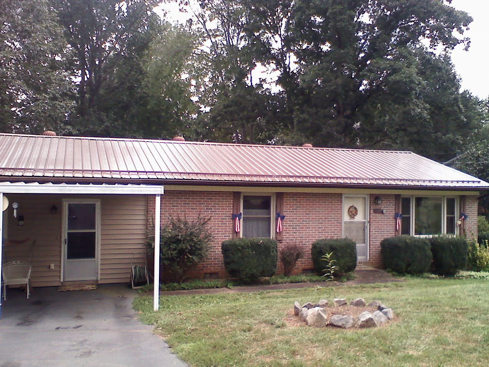 Bronze metal roof and carport on a brick ranch home — Roof Repair work by our crew in Hickory Hills