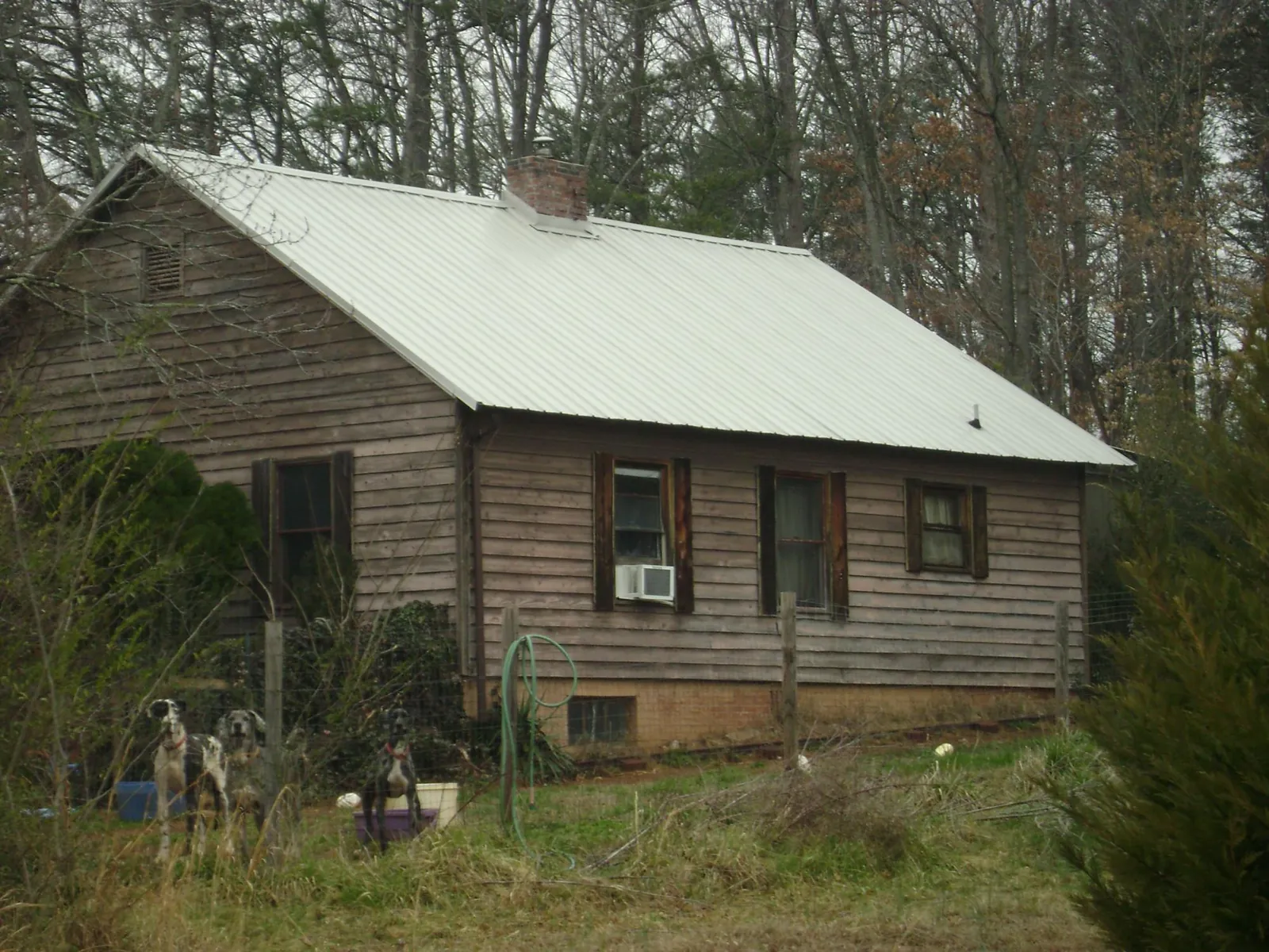 White metal roof on an old wood sided farmhouse, from a Asphalt Shingle Roof Repair job in Hickory Hills